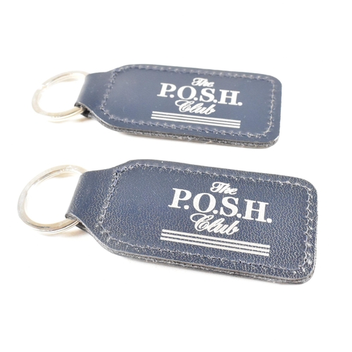 55 - Two 1990s hallmarked silver and leather tag keyrings. The silver tags backed with navy blue leather ... 