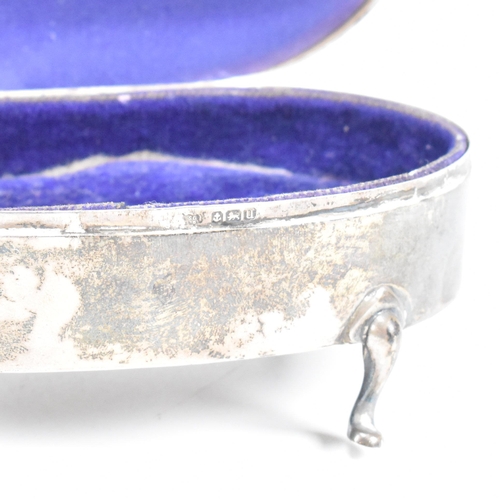 56 - A George V hallmarked silver mounted jewellery box. The trinket box having for hoof feet, rising to ... 