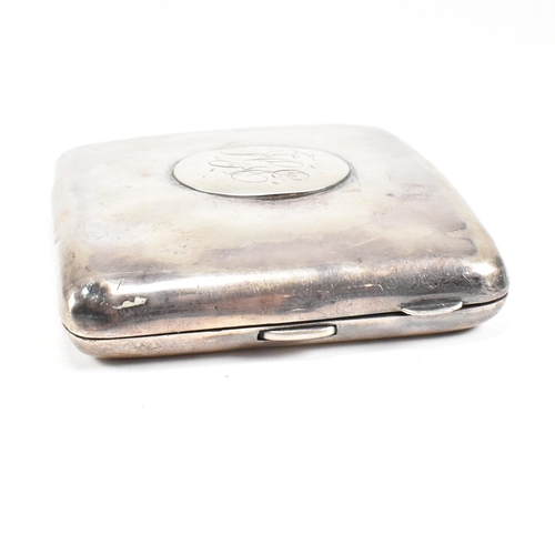 57 - A George V Hallmarked silver cigarette case. The case having a central monogrammed cartouche to fron... 