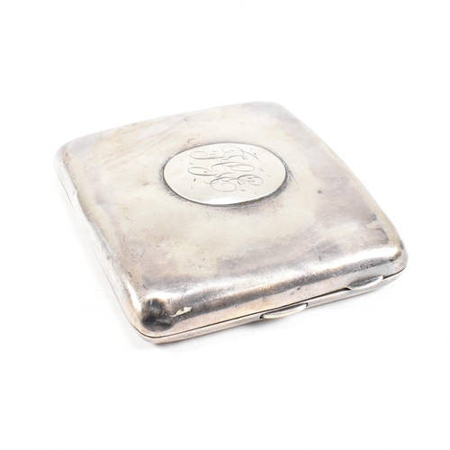 57 - A George V Hallmarked silver cigarette case. The case having a central monogrammed cartouche to fron... 