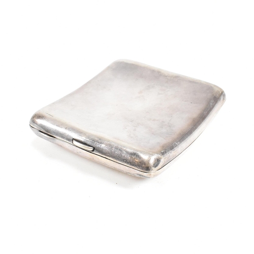 57 - A George V Hallmarked silver cigarette case. The case having a central monogrammed cartouche to fron... 