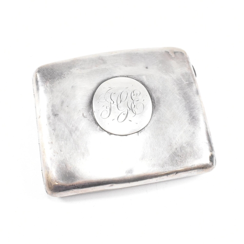 57 - A George V Hallmarked silver cigarette case. The case having a central monogrammed cartouche to fron... 