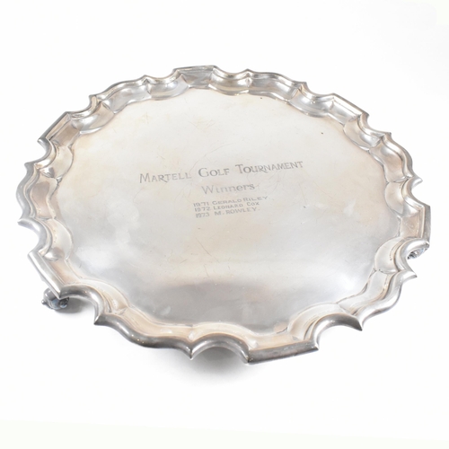 61 - An Edward VII hallmarked Irish silver salver. The salver having four scrolled hoof feet rising to tr... 