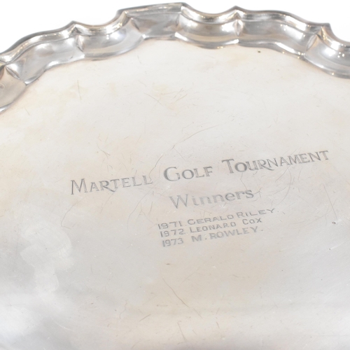 61 - An Edward VII hallmarked Irish silver salver. The salver having four scrolled hoof feet rising to tr... 