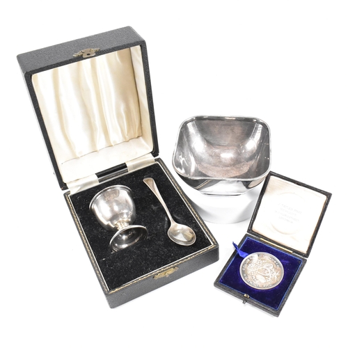 64 - A collection of hallmarked silver and white metal items. The lot to include a Vintage cased Christen... 