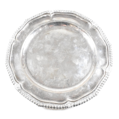 7 - A Victorian Irish hallmarked silver salver. The salver having a stepped rim with serpentine edge, ra... 