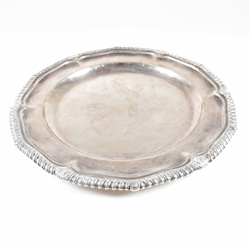 7 - A Victorian Irish hallmarked silver salver. The salver having a stepped rim with serpentine edge, ra... 