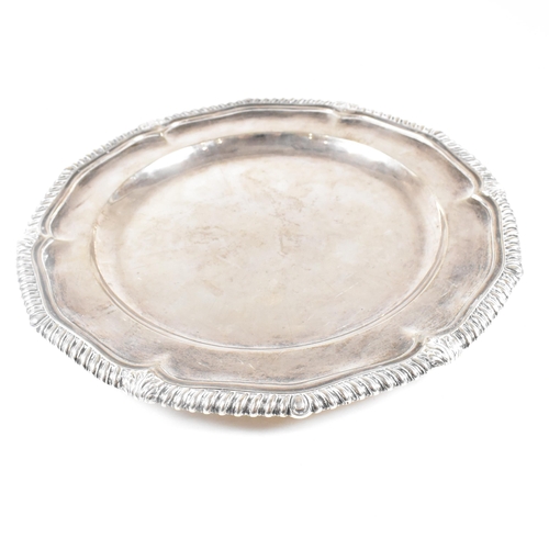 7 - A Victorian Irish hallmarked silver salver. The salver having a stepped rim with serpentine edge, ra... 