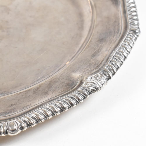 7 - A Victorian Irish hallmarked silver salver. The salver having a stepped rim with serpentine edge, ra... 