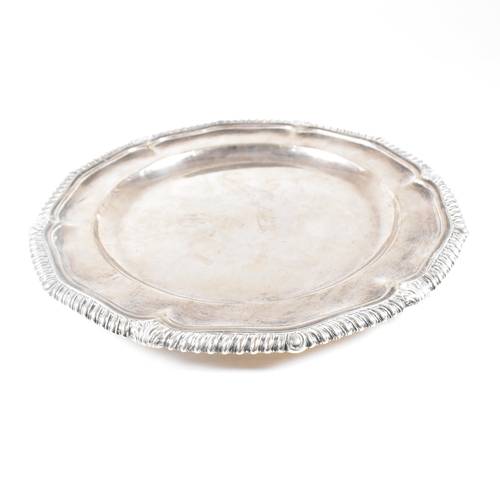 7 - A Victorian Irish hallmarked silver salver. The salver having a stepped rim with serpentine edge, ra... 