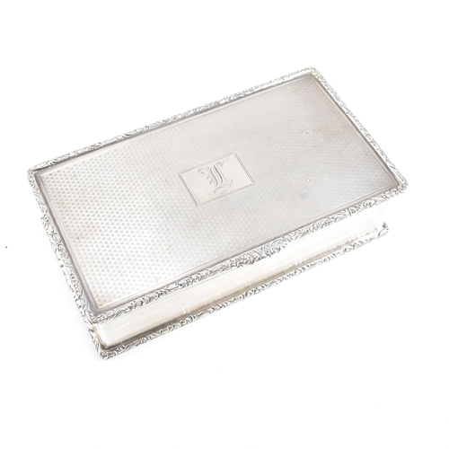 71 - A George V hallmarked silver cigarette box. The Georgian cigar box having an engine turned design to... 