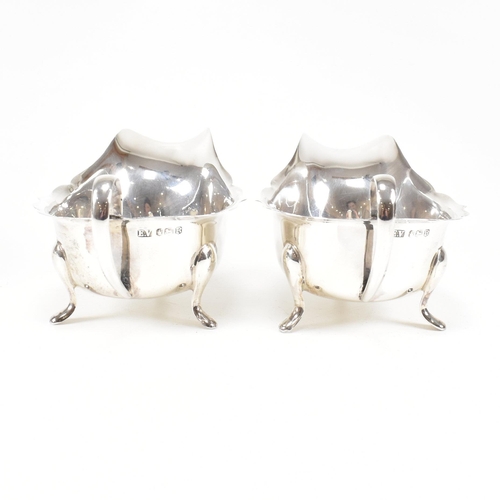 77 - A pair of mid-centuryÿ hallmarked silver sauce boats. The pair having three hoof feet rising to jugu... 