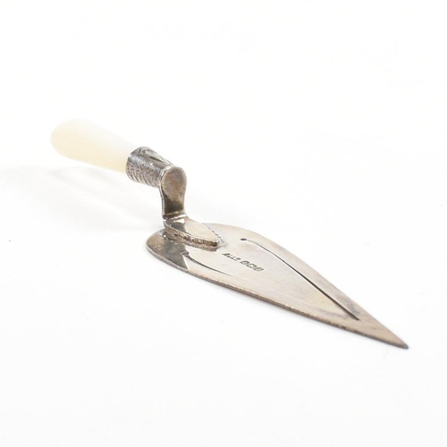 82 - A George V hallmarked silver and mother of pearl novelty bookmark in the form of a trowel.  Hallmark... 