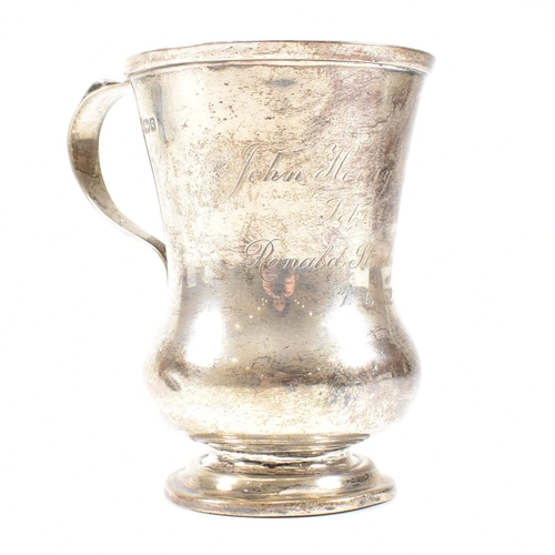 84 - George V hallmarked silver trophy cup. The cup having a circular stepped plinth base raising to a bu... 