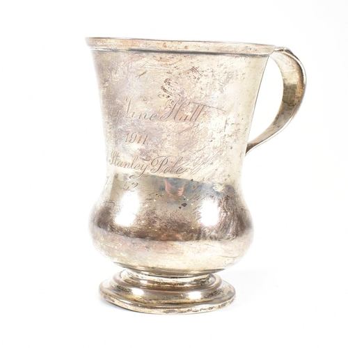 84 - George V hallmarked silver trophy cup. The cup having a circular stepped plinth base raising to a bu... 