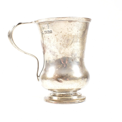 84 - George V hallmarked silver trophy cup. The cup having a circular stepped plinth base raising to a bu... 