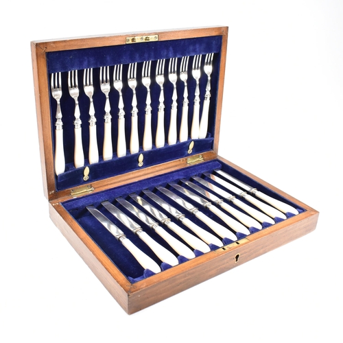 87 - A 1970s cased set of hallmarked silver collared with mother of pearl flatware. The set comprising of... 