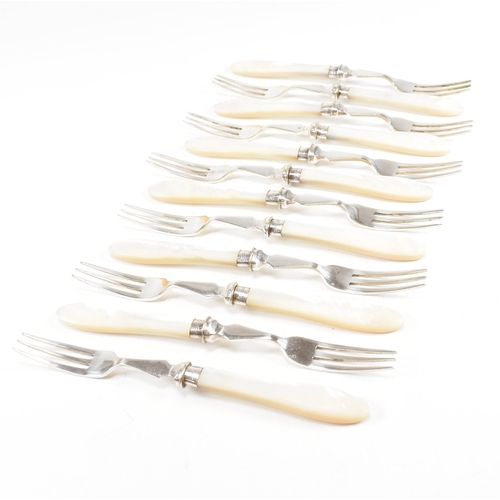 87 - A 1970s cased set of hallmarked silver collared with mother of pearl flatware. The set comprising of... 