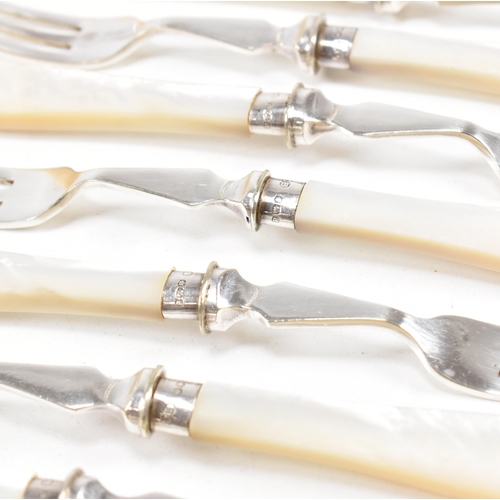 87 - A 1970s cased set of hallmarked silver collared with mother of pearl flatware. The set comprising of... 