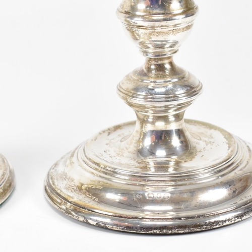 91 - A pair ofÿ mid-century hallmarked silver squat candlesticks. The candlesticks having a weighted base... 