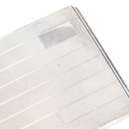 97 - A George VI hallmarked silver cigarette case. The case having an engine turned stripe pattern to the... 