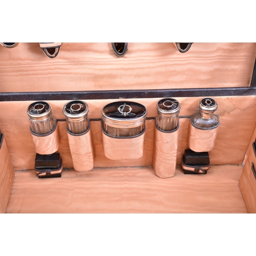 210 - A 1920s hallmarked silver and tortoiseshell leather cased travelling vanity set. The suite to includ... 