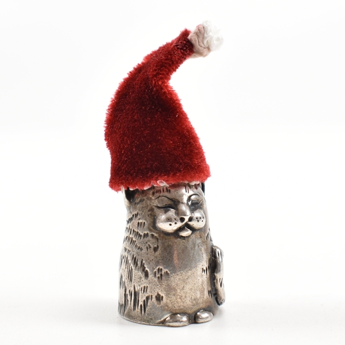 1 - A hallmarked silver novelty thimble in the form of a dozing cat. Hallmarked London 1987. Sponsors ma... 