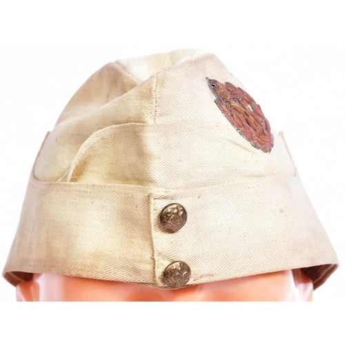 106 - A WWI First World War RFC Royal Flying Corps officers uniform side cap. The cap bronze cap badge and... 