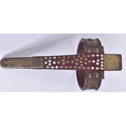 111 - An early 20th Century Berber / Tuareg tribal arm dagger. Dome shaped pommel with a cruciform hilt wi... 