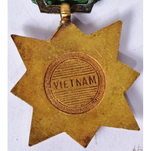 121 - A Vietnam War era South Vietnam Civil Actions medal (Dan Vu Boi Tinh). Bronze 8 pointed star superim... 