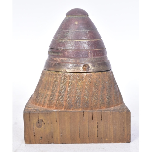 141 - A WWI First World War British 18 Pounder inert shrapnel shell fuse displayed on a wooden plinth. The... 