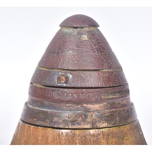 141 - A WWI First World War British 18 Pounder inert shrapnel shell fuse displayed on a wooden plinth. The... 