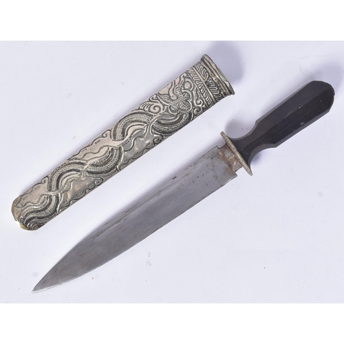 174 - A late 19th Century Tibetan /  Bhutanese dagger. Waisted horn hilt with a white metal guard, single ... 