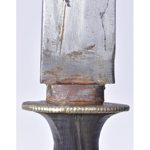 174 - A late 19th Century Tibetan /  Bhutanese dagger. Waisted horn hilt with a white metal guard, single ... 