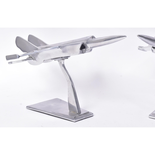 184 - Two vintage chrome metal models of military aircrafts / fighter jets. Each measuring approx 23x40cm.