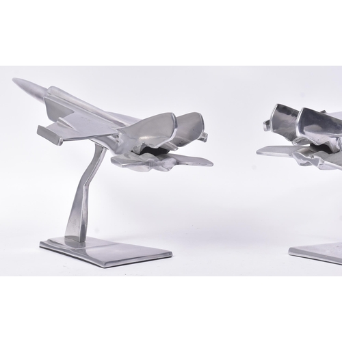 184 - Two vintage chrome metal models of military aircrafts / fighter jets. Each measuring approx 23x40cm.