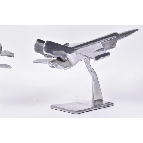 184 - Two vintage chrome metal models of military aircrafts / fighter jets. Each measuring approx 23x40cm.