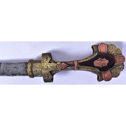 194 - An early 20th Century Middle Eastern / Syrian Jambiya dagger. Wooden hilt with applied brass and cop... 