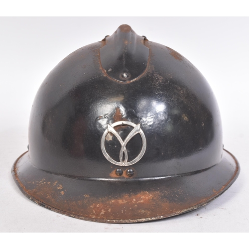 197 - A WWII Second World War French Milice helmet. The black Adrian pattern helmet with a metal ' Gamma '... 