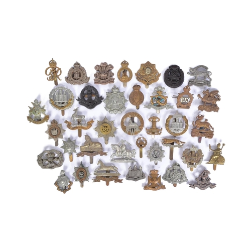 206 - A collection of pre and post WWII Second World War British Army cap badges to include; Royal Berkshi... 