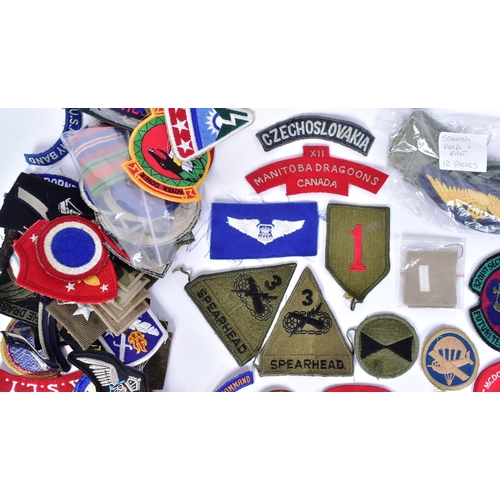 218 - A large collection of assorted Military badges / patches to include RAF Wings (Engineer, Bomb Air Cr... 