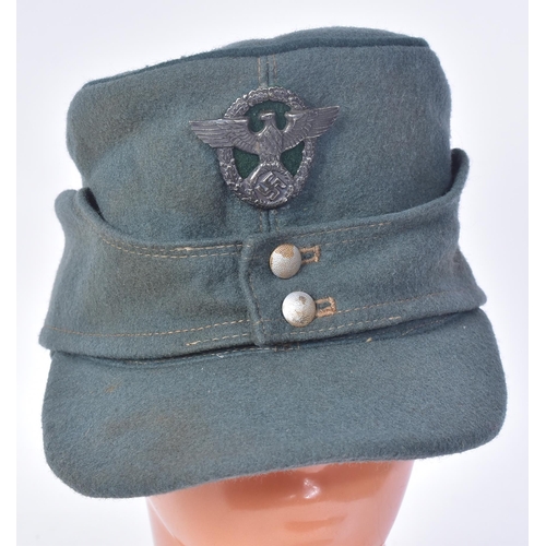 228 - A WWII Second World War Third Reich Nazi German Field Police M42 cap. Green wool with a front Police... 