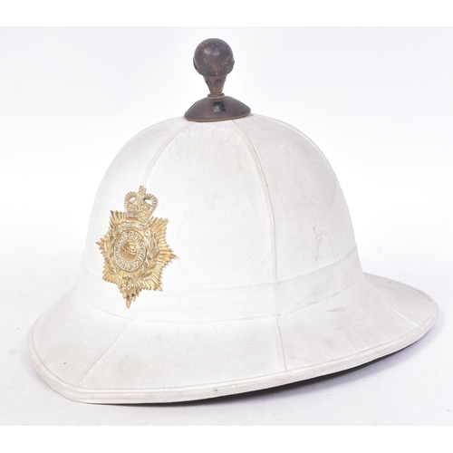 263 - An original post war 1960 dated Royal Marines Band pith helmet. A complete example with liner, badge... 