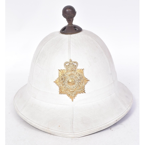 263 - An original post war 1960 dated Royal Marines Band pith helmet. A complete example with liner, badge... 