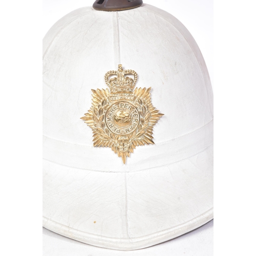 263 - An original post war 1960 dated Royal Marines Band pith helmet. A complete example with liner, badge... 