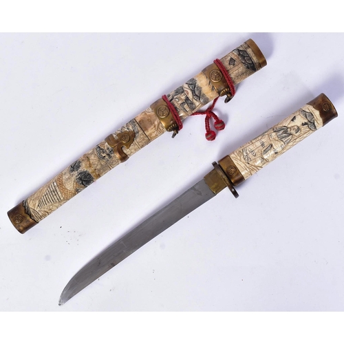 268 - A 20th Century Japanese Tanto knife / dagger with bone scrimshaw handle and scabbard. Extensively ca... 