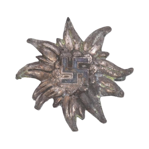 302 - A WWII Second World War Third Reich Nazi German Ski badge. Edelweiss flower shape with a black ename... 