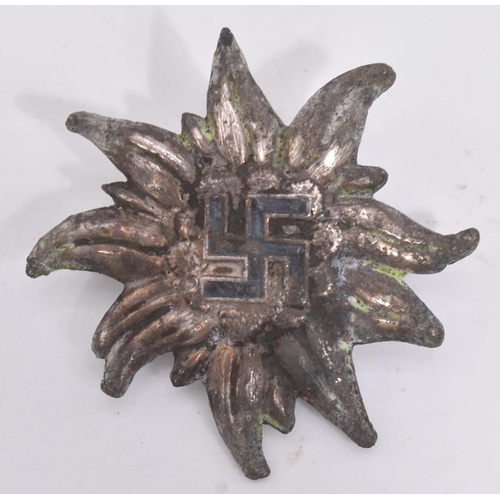 302 - A WWII Second World War Third Reich Nazi German Ski badge. Edelweiss flower shape with a black ename... 