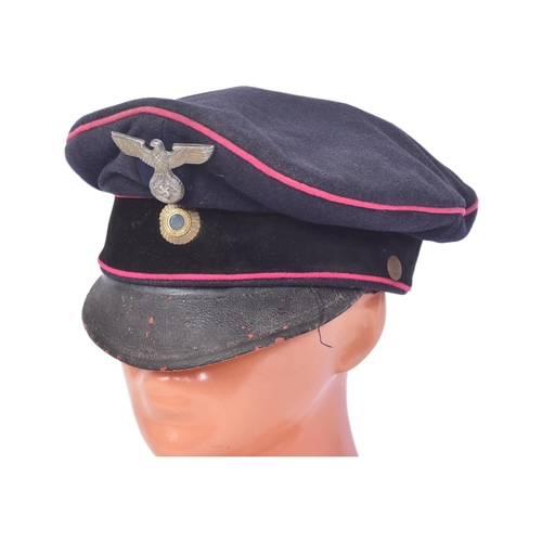 305 - A WWII Second World War Third Reich Nazi German Fireman's visor cap. Dark blue wool construction wit... 