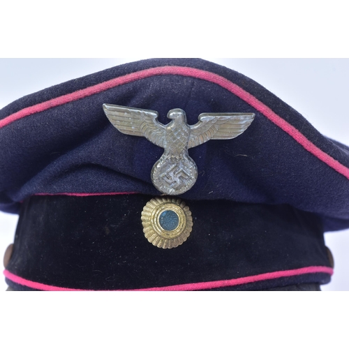 305 - A WWII Second World War Third Reich Nazi German Fireman's visor cap. Dark blue wool construction wit... 